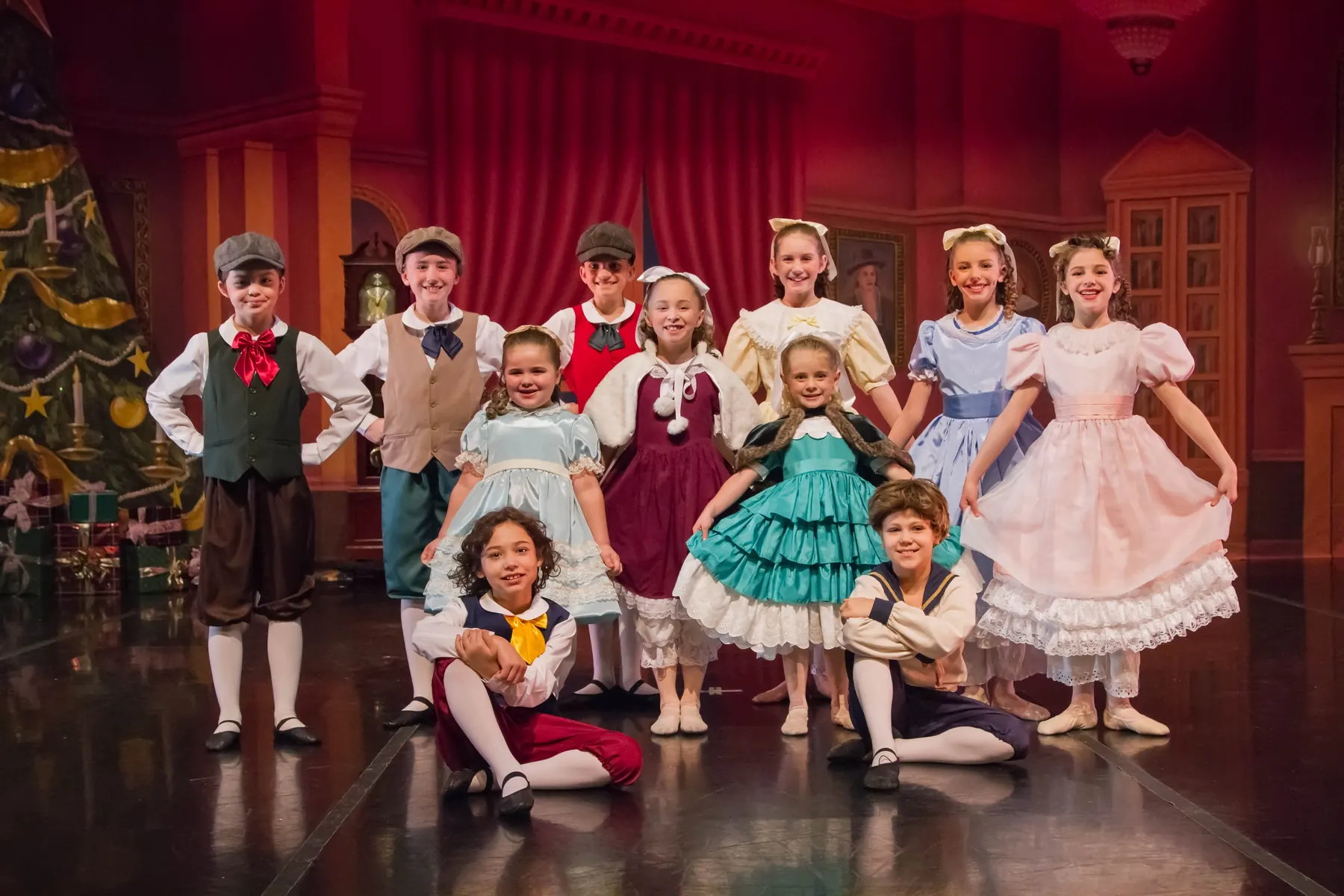 Children from the Nutcracker party scene pose together on the Ballet for Youth stage